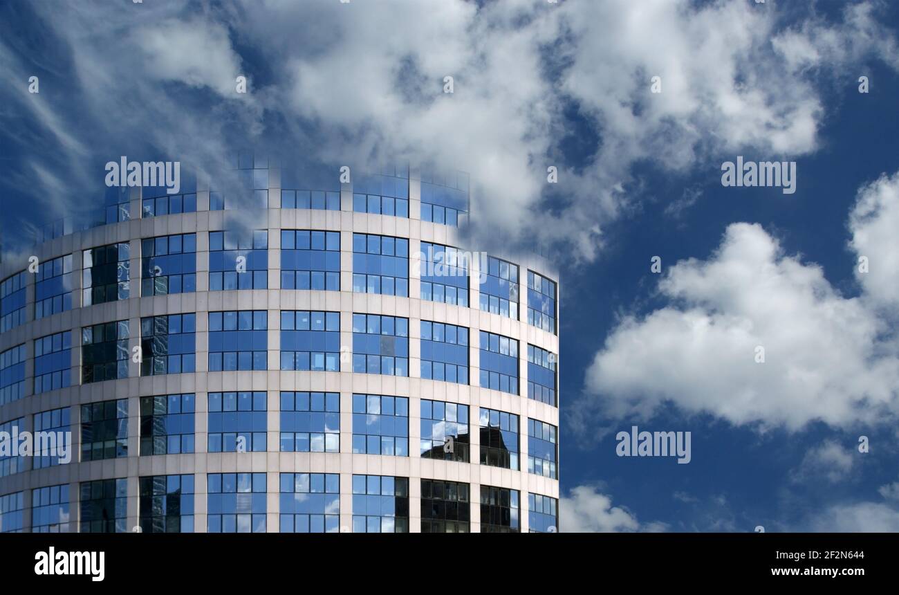 Reflection of a cloudy sky in glass wall of an office building Stock ...