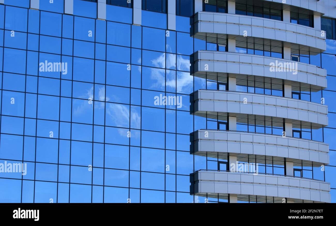 Reflection of a cloudy sky in glass wall of an office building Stock ...