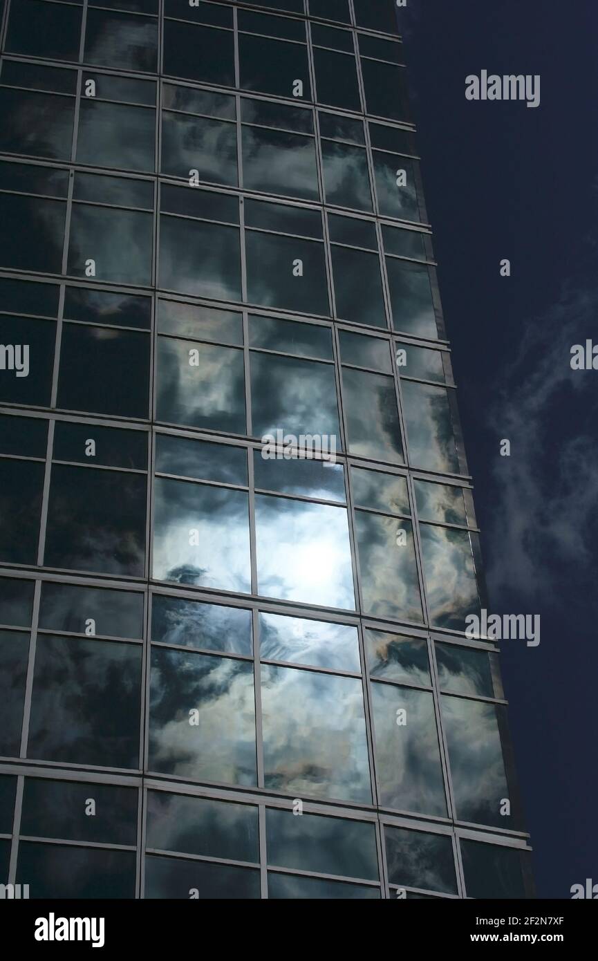 Reflection of a cloudy sky in glass wall of an office building Stock ...