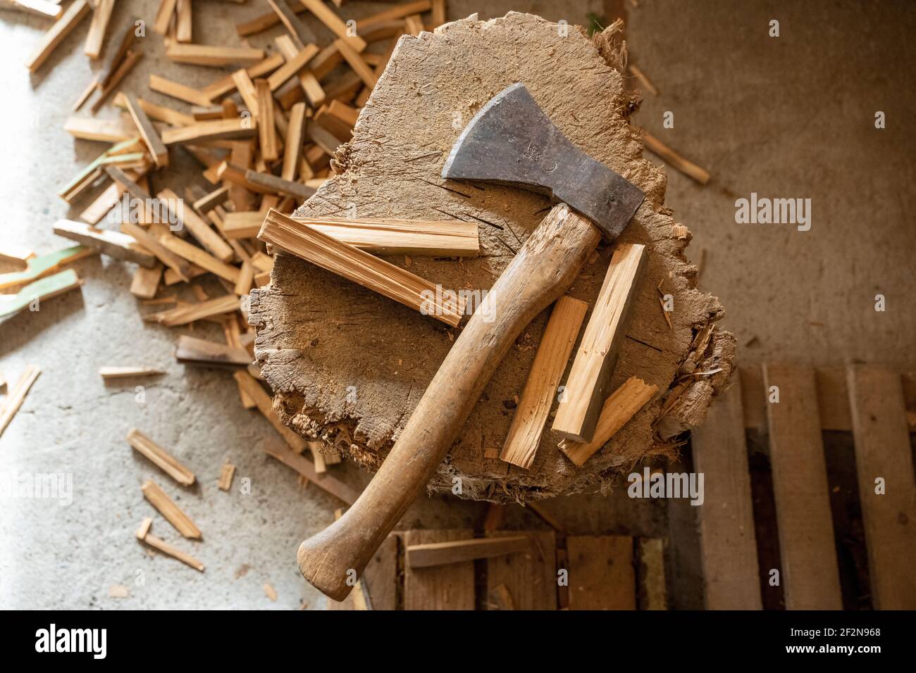 Chopping block with ax and split wood. Stock Photo