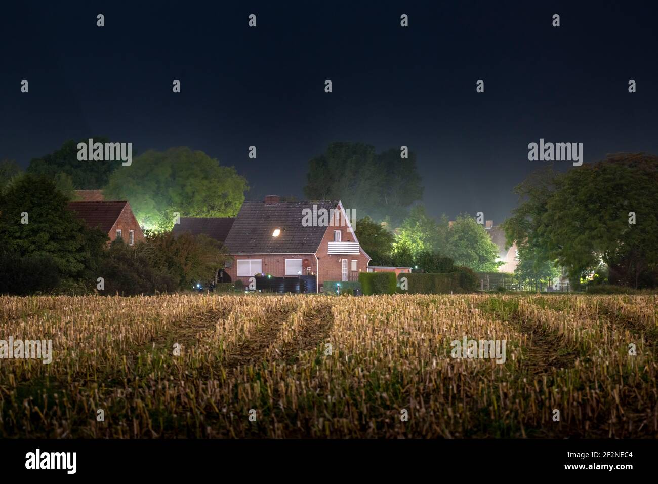 Germany, Lower Saxony, East Frisia, Krummhörn, housing estate at night. Stock Photo