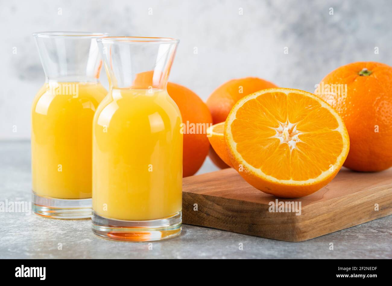Glass pitchers of juice with slice of orange fruit Stock Photo