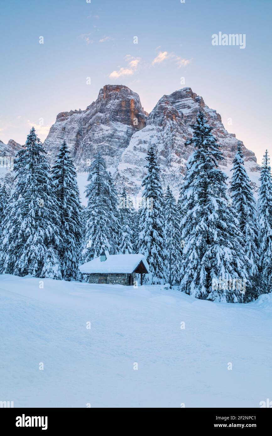small alpine chapel at the foot of mount pelmo, snowy forest in Dolomites. Selva di Cadore, Belluno province, Veneto, Italy Stock Photo