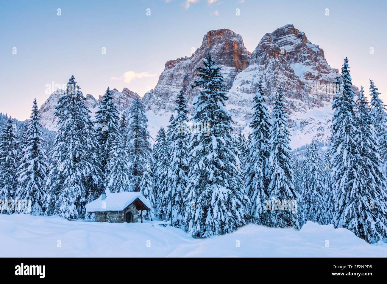 small alpine chapel at the foot of mount pelmo, snowy forest in Dolomites. Selva di Cadore, Belluno province, Veneto, Italy Stock Photo