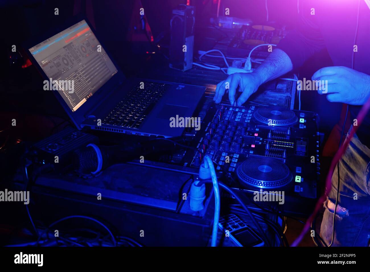 DJ mixing music on turntable console at in the night club Stock Photo