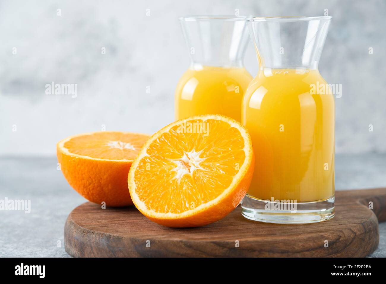 Glass pitchers of juice with slice of orange fruit Stock Photo