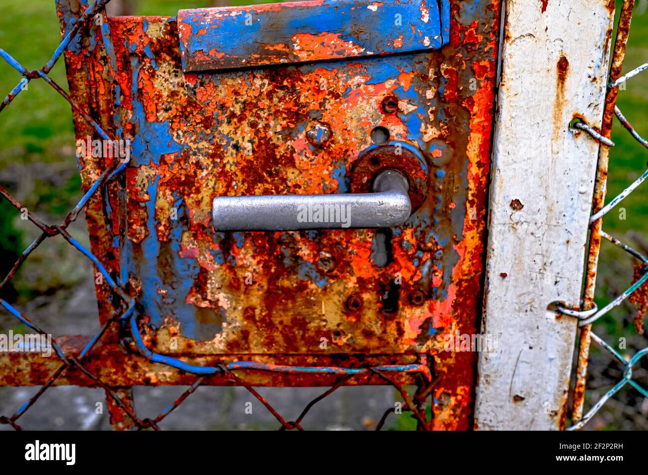Old door handle on a rusted gate Stock Photo