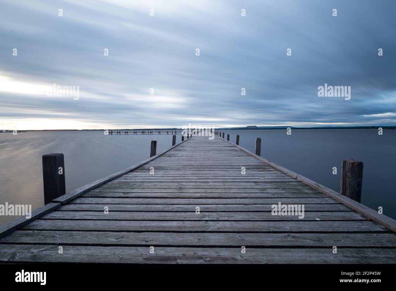 pier on the lake steinhude with reflections on water Stock Photo
