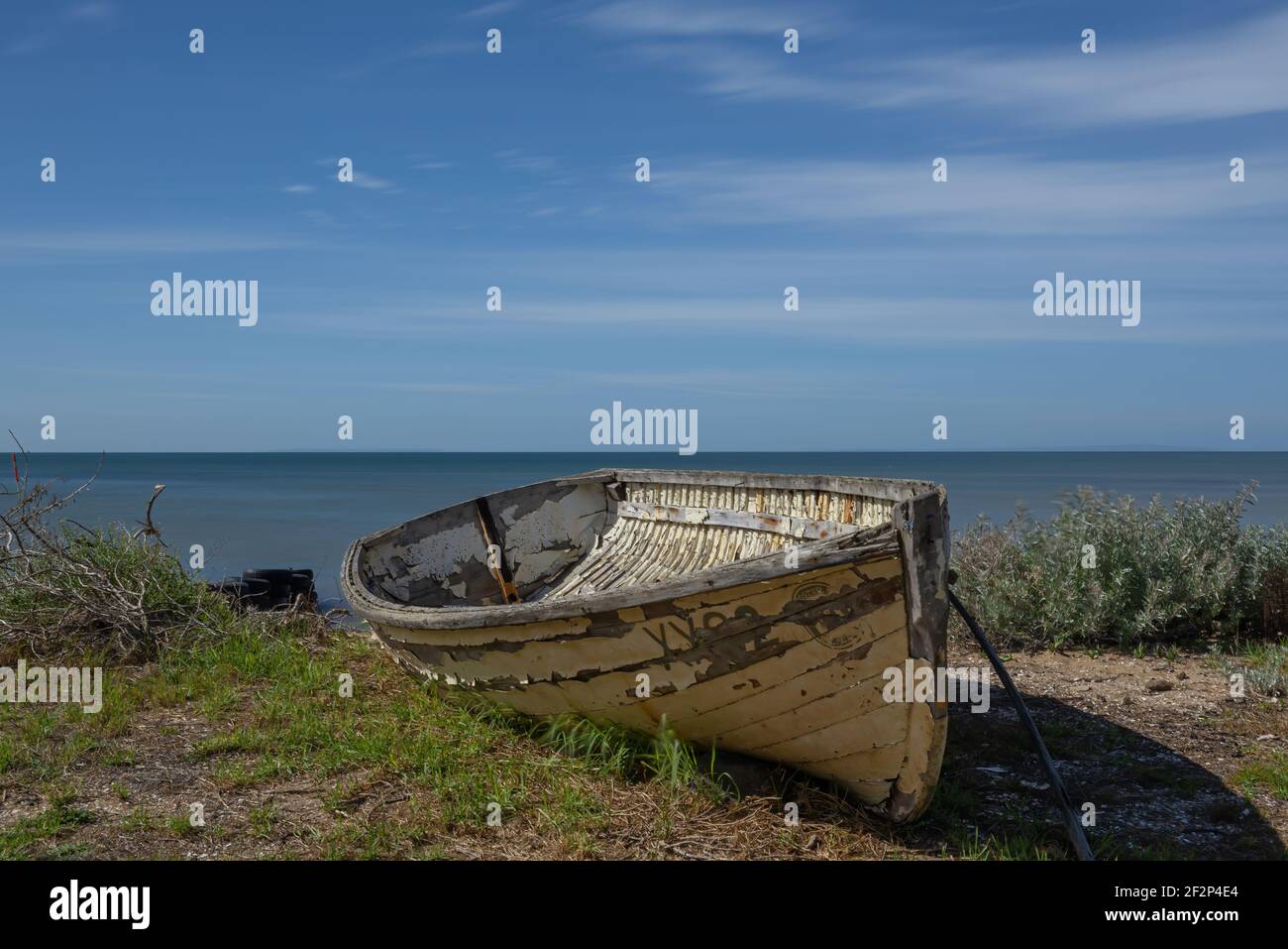 An old wooden fishing boat at rest on the shore Stock Photo - Alamy