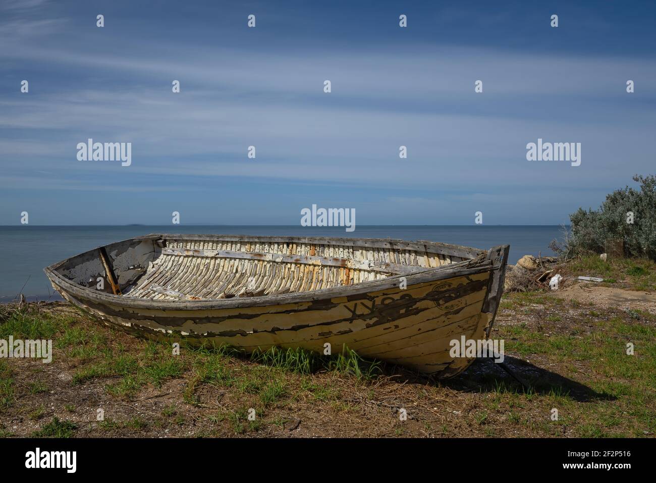 An old wooden fishing boat at rest on the shore Stock Photo - Alamy