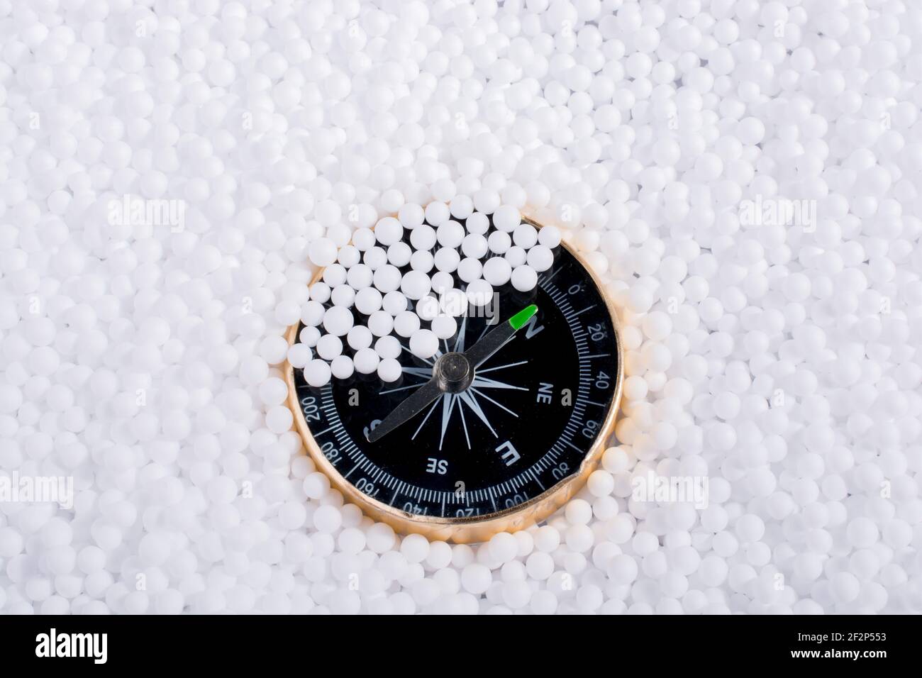 compass on little white polystyrene foam balls Stock Photo - Alamy