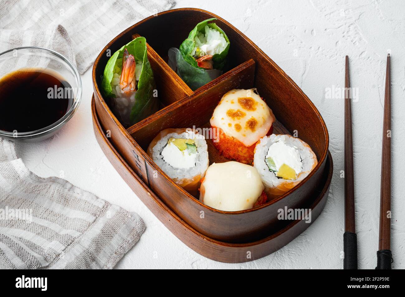 Homemade Sushi Bento Box with Sushi Rolls set, on white stone ...