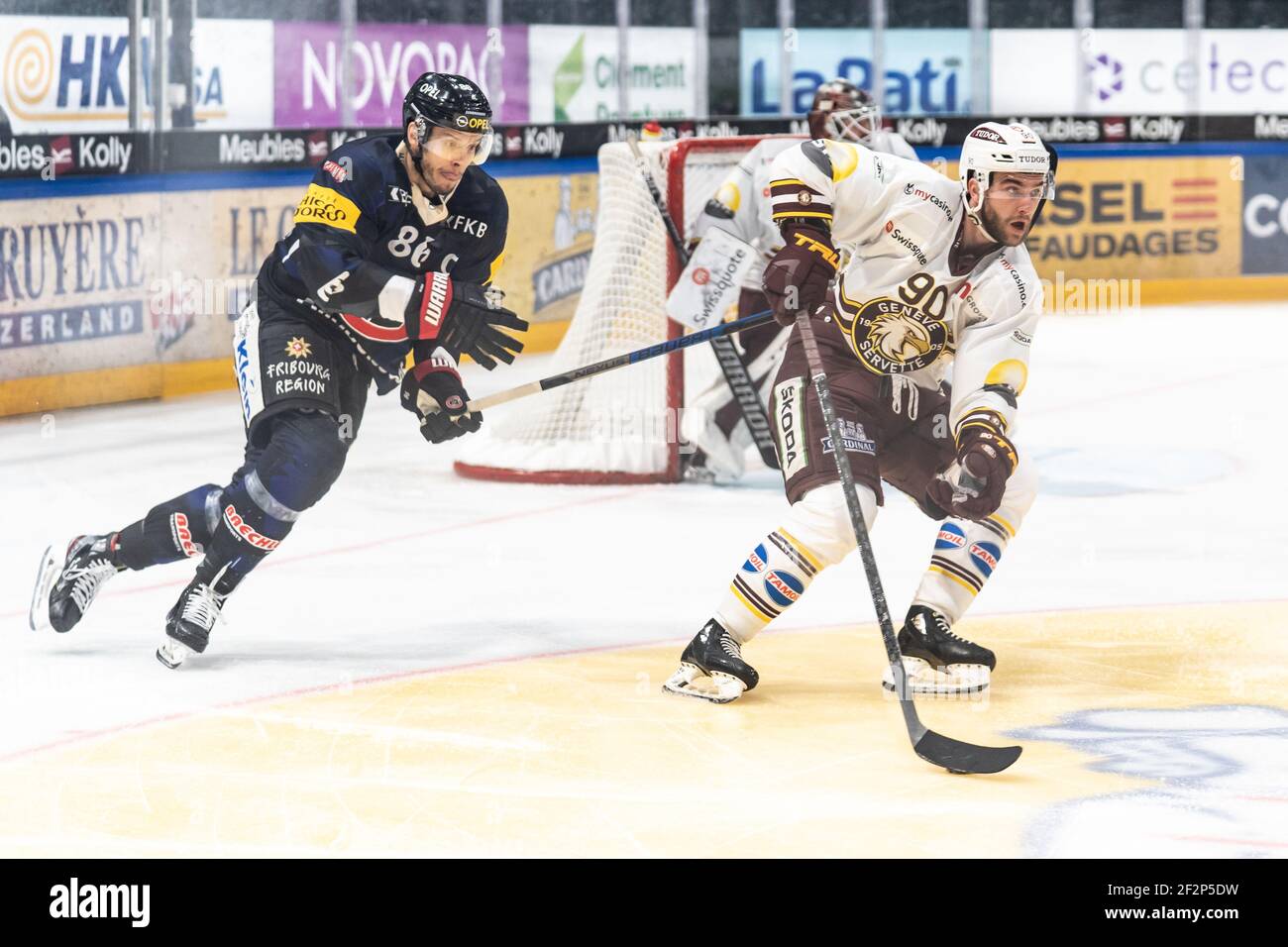 Friborg, Friborg. 12th Mar, 2021. March 12th, 2021, Friborg, BCF Arena, National League: Friborg-Gotteron - Geneve-Servette HC, at the puck # 90 Simon Le Coultre (Geneva) in the background # 86 Julien Sprunger (Friborg) (Switzerland/Croatia OUT) Credit: SPP Sport Press Photo. /Alamy Live News Stock Photo
