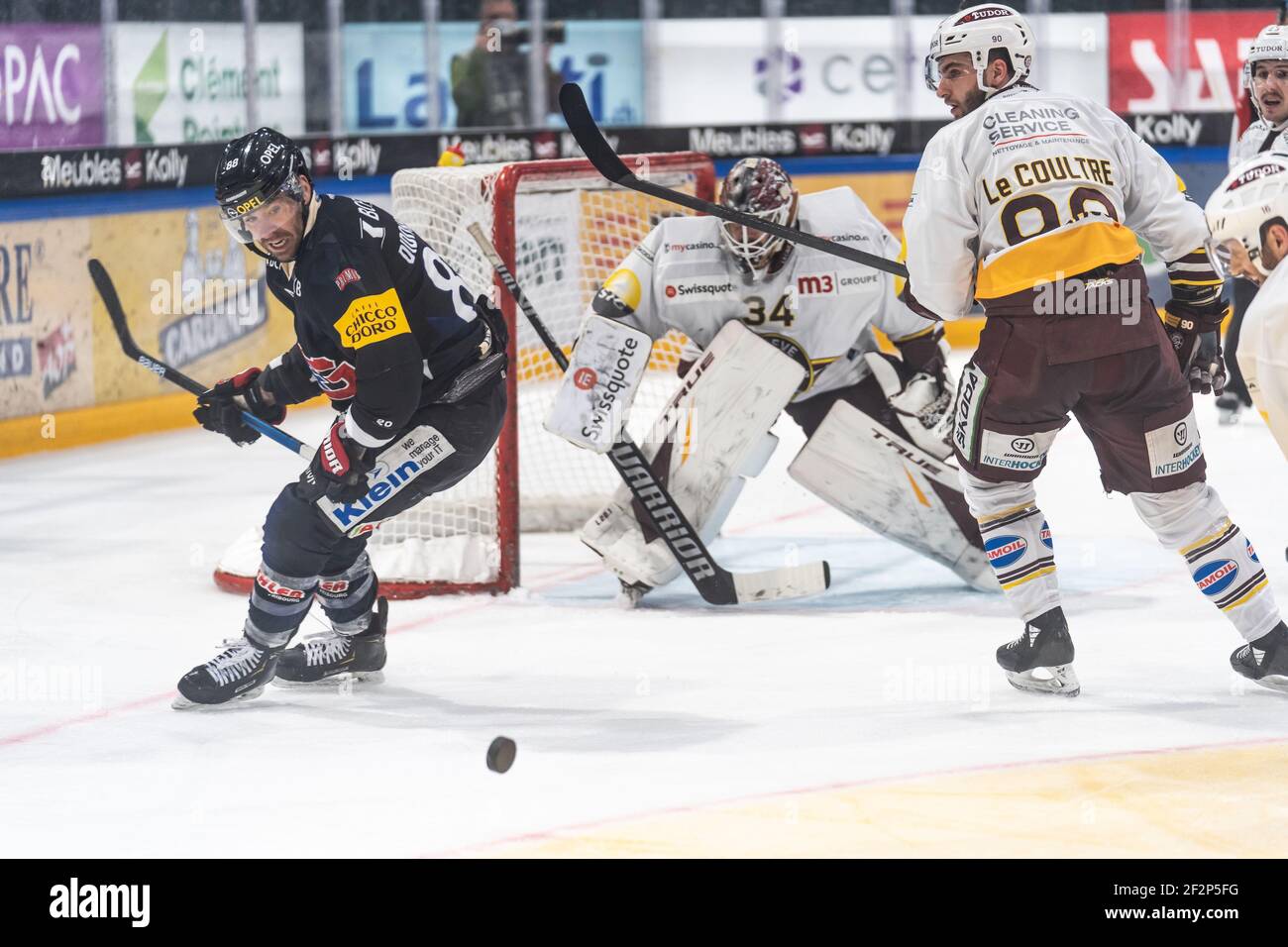 Friborg, Friborg. 12th Mar, 2021. March 12th, 2021, Friborg, BCF Arena, National League: Friborg-Gotteron - Geneve-Servette HC, # 88 Christopher DiDomenico (Friborg) looks at the puck in the background # 90 Simon Le Coultre (Geneva) (Switzerland/Croatia OUT) Credit: SPP Sport Press Photo. /Alamy Live News Stock Photo
