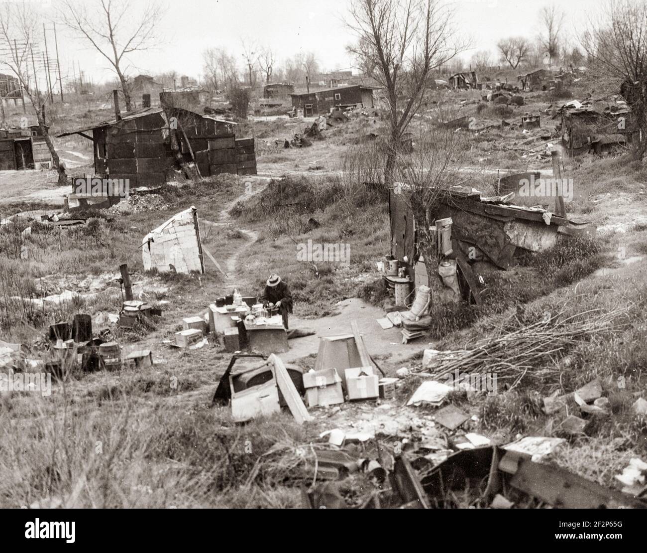 Migrant workers' camp, outskirts of Marysville, California. The new migratory camps now being built by the Resettlement Administration will remove people from unsatisfactory living conditions such as these and substitute at least the minimum of comfort and sanitation. April 1935 . Photograph by Dorothea Lange. Stock Photo