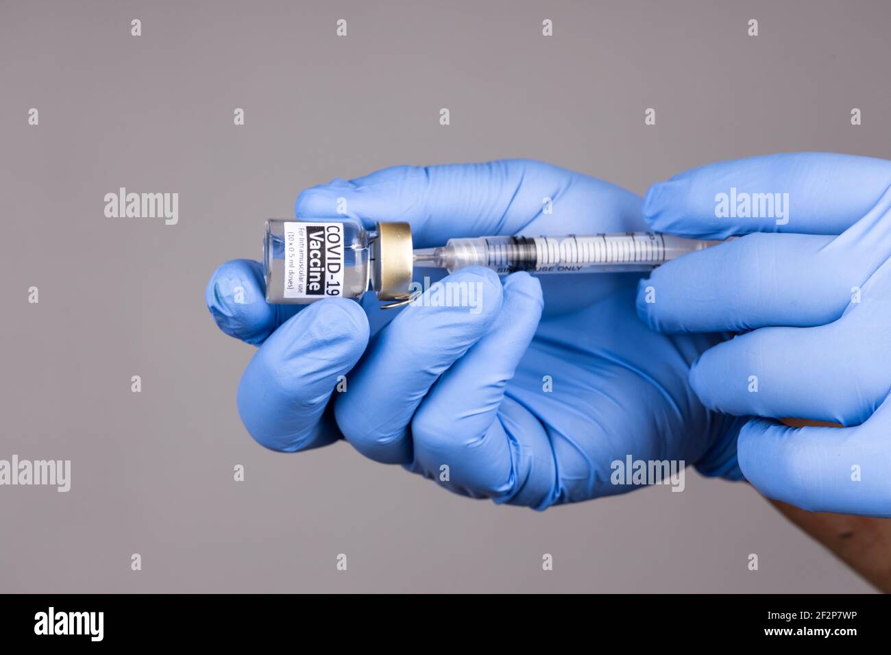 Closeup of hand with surgical glove insert syringe into covid19 vaccine vial Stock Photo Alamy