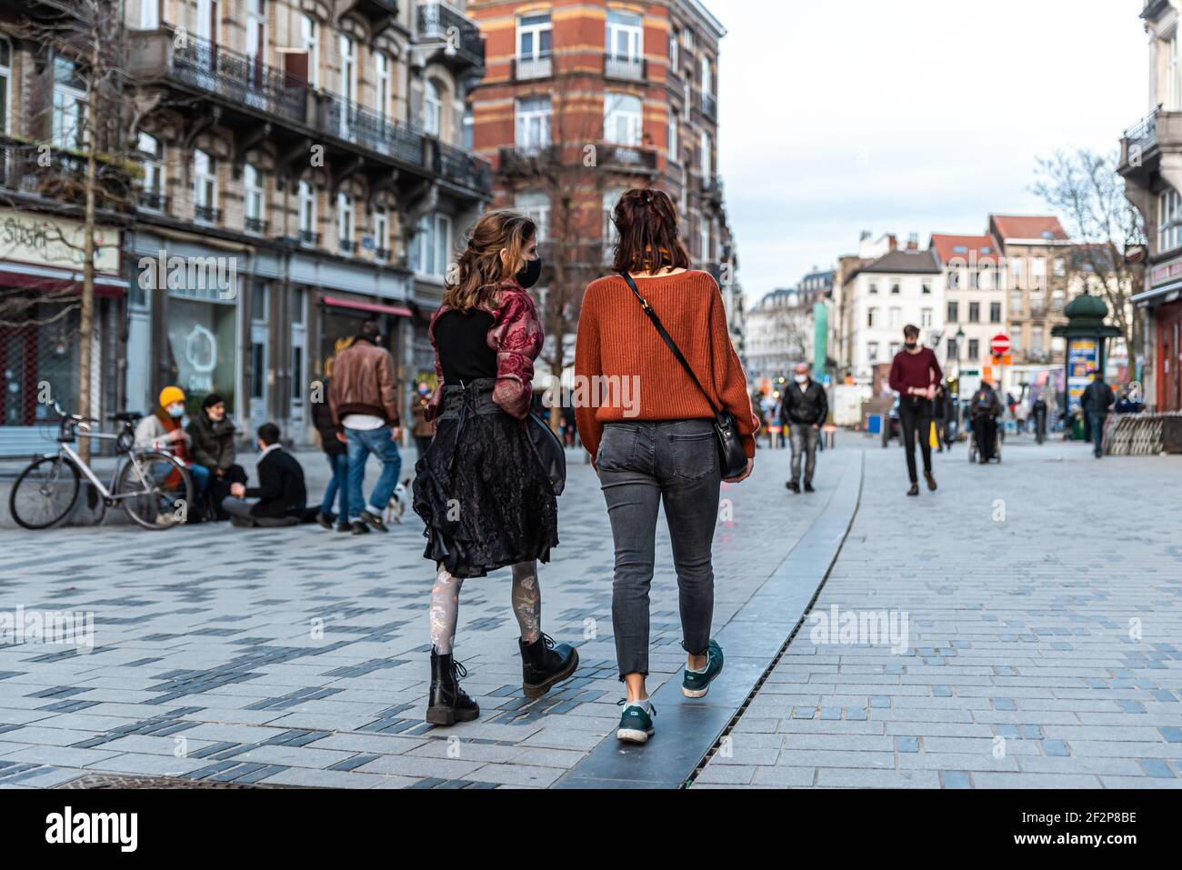 Saint- Gilles, Brussels Capital Region - Belgium: 02 26 2021: Fashionable girls going out at the Parvis market square Stock Photo