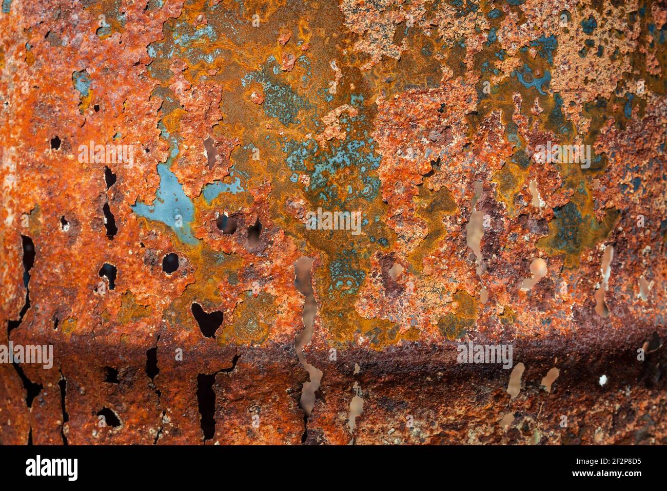 Close up texture detail of orange and brown rusty metal corroded plate Stock Photo