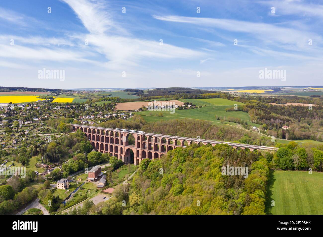 Largest brick arch bridge in the world (574 m long, 78 m high) Train, houses, valley, forest Stock Photo