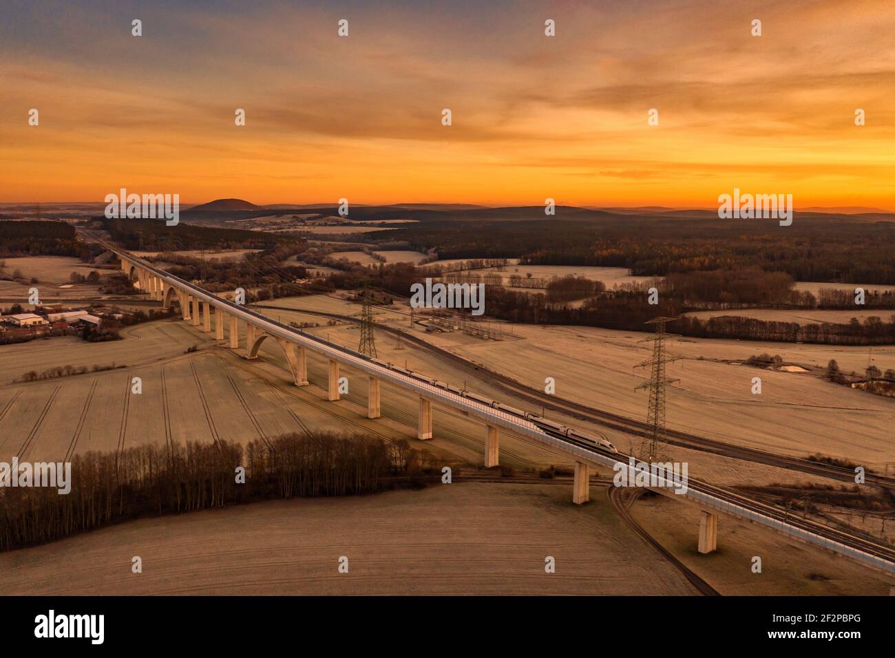 ICE, longest bridge in Thuringia (1681 m long, 48 m high), high-voltage pylons, power line, morning mood, aerial view Stock Photo