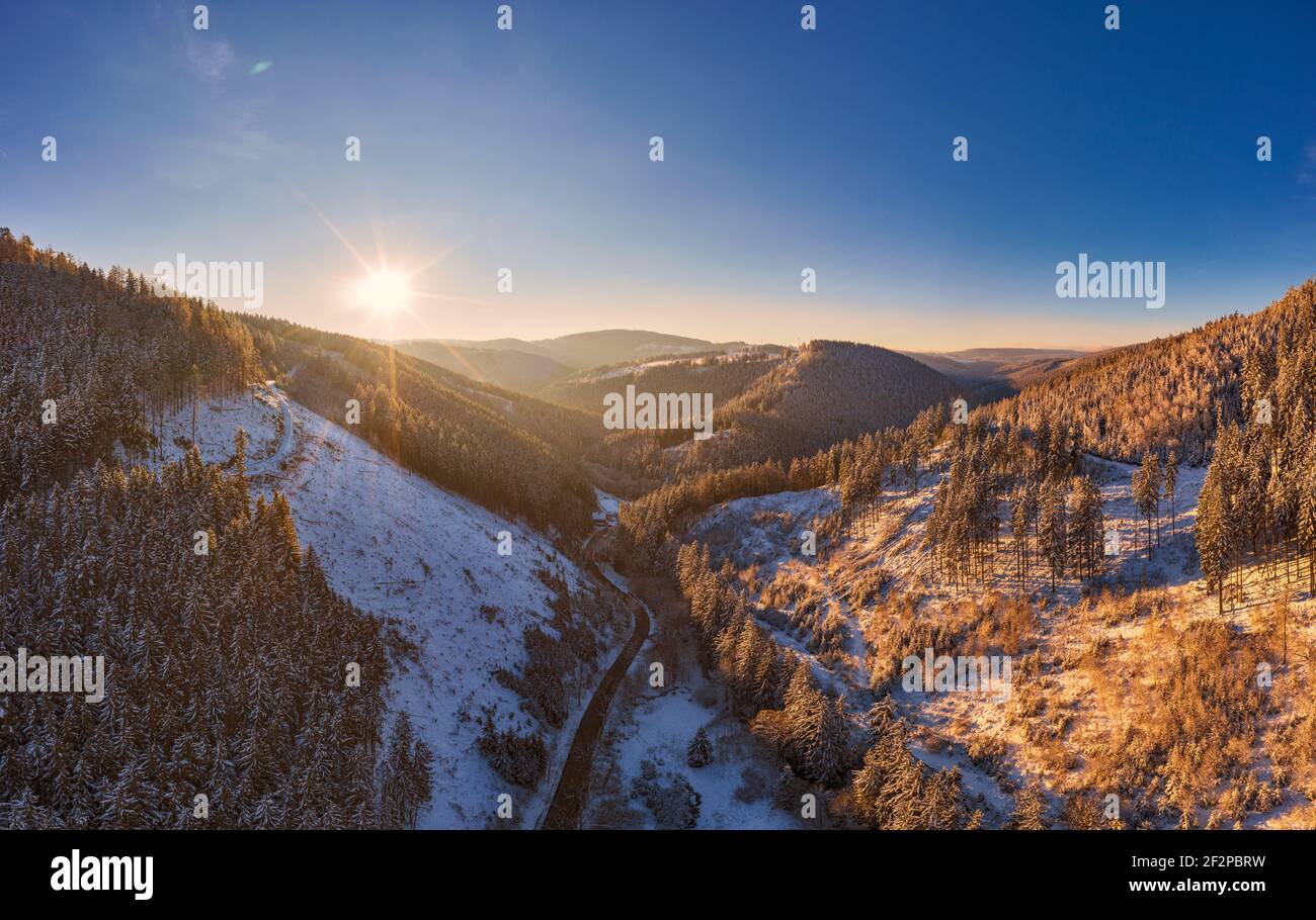 Germany, Thuringia, Grossbreitenbach, Allersdorf, valley, forest, mountains, road, snow, sunrise, back light Stock Photo