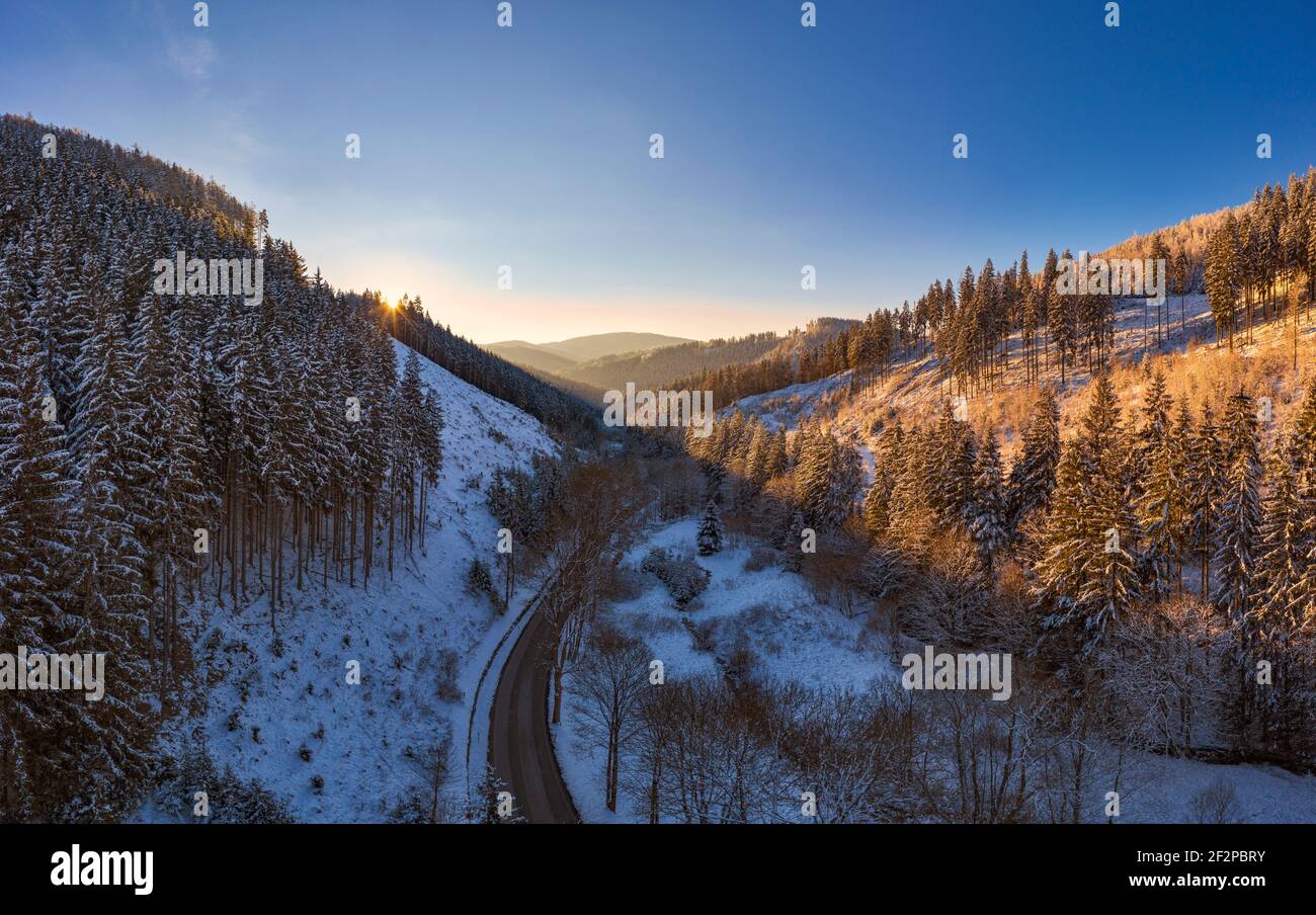 Germany, Thuringia, Grossbreitenbach, Allersdorf, forest, valley, mountains, road, snow, sunrise, back light Stock Photo