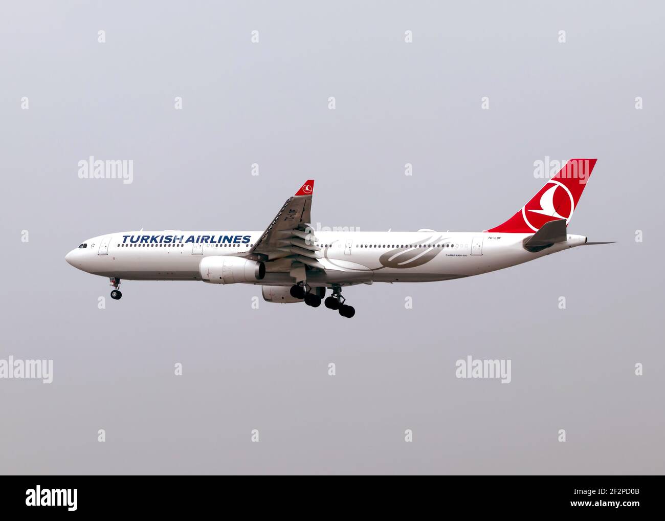 London, Heathrow Airport - April 2019: Turkish Airlines, Airbus A330 flying over London through an overcast sky with no clouds. Image Abdul Quraishi Stock Photo