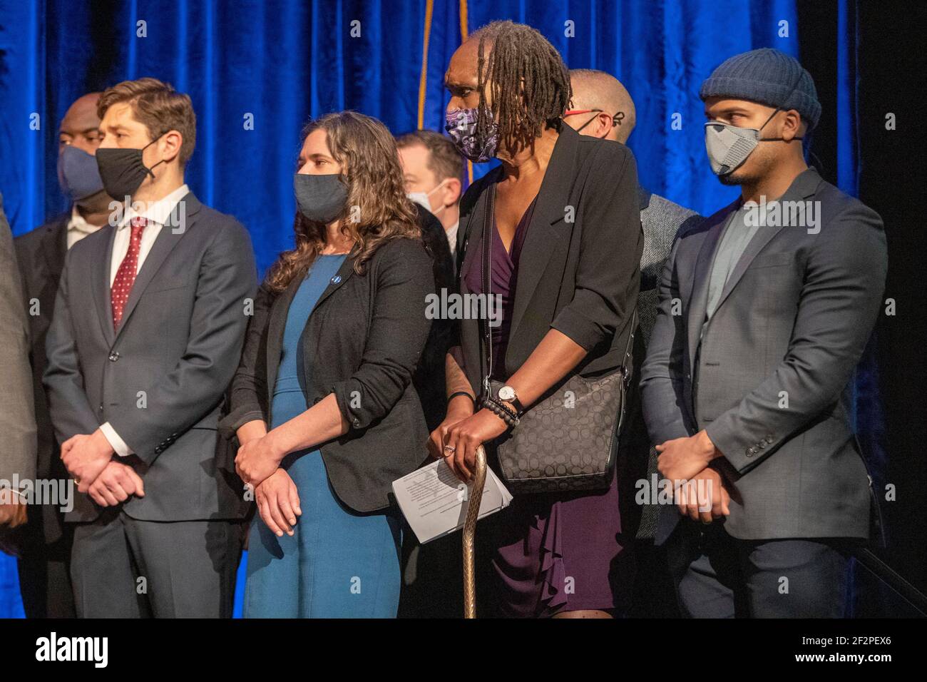 Minneapolis, Minnesota, USA. 12th Mar, 2021. Minneapolis City Council members, and Mayor Jacob Frey (red tie) listen to attorney Benjamin Crump speak dyring a press conference after the Minneapolis City Council approve a 27 million dollar settlement with the Floyd family. Credit: Chris Juhn/ZUMA Wire/Alamy Live News Stock Photo