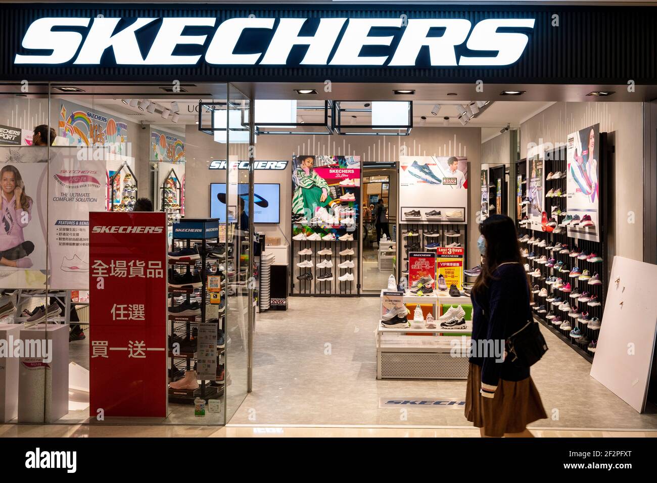 Hong Kong, China. 12th Mar, 2021. A woman walks past the American lifestyle  and performance footwear brand, Skechers store seen in Hong Kong. (Photo by  Chukrut Budrul/SOPA Images/Sipa USA) Credit: Sipa USA/Alamy