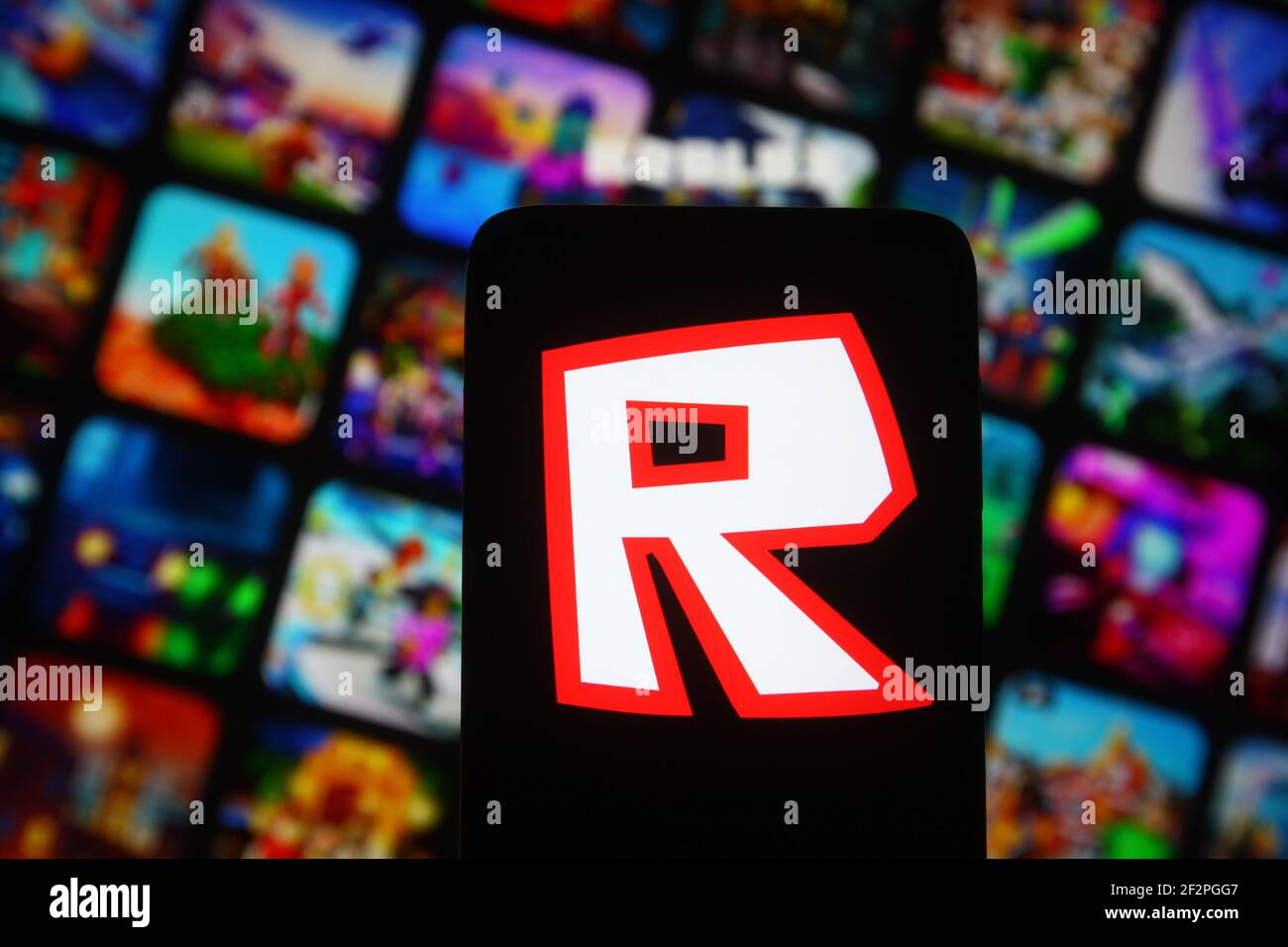 Roblox Logo and App on a Mobile Screen in a Hand Editorial Stock