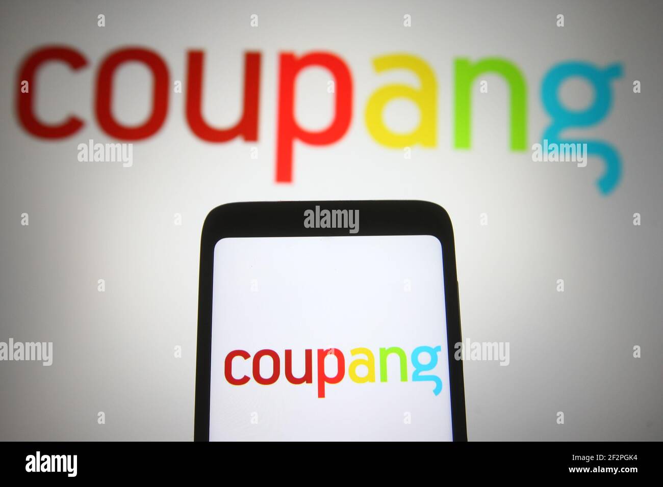 Ukraine. 12th Mar, 2021. In this photo illustration a Coupang logo of a South Korean e-commerce company is seen on a smartphone and a pc screen. (Photo by Pavlo Gonchar/SOPA Images/Sipa USA) Credit: Sipa USA/Alamy Live News Stock Photo