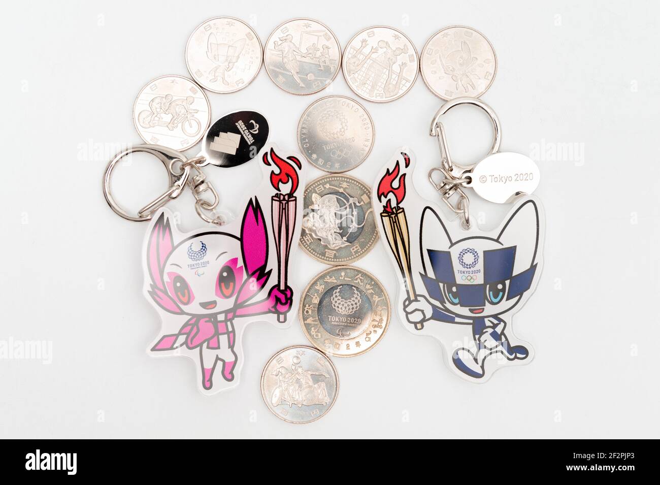 Tokyo, Japan - January 4, 2021: Mascot keychains and commemorative coins of 100 yen and 500 yen for the Tokyo 2020 Olympics. Stock Photo