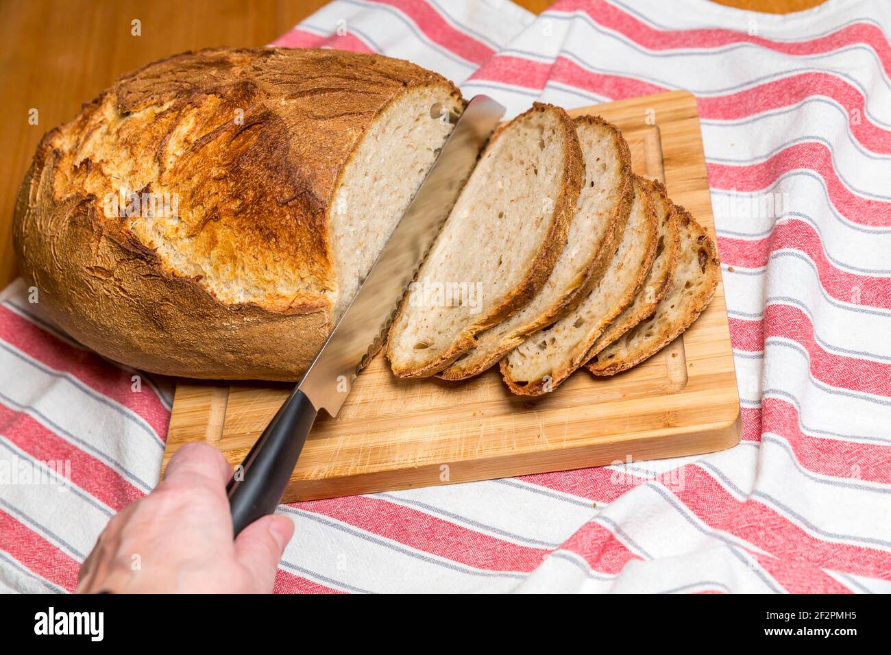 Fresh homemade organic bread on wooden plate Stock Photo