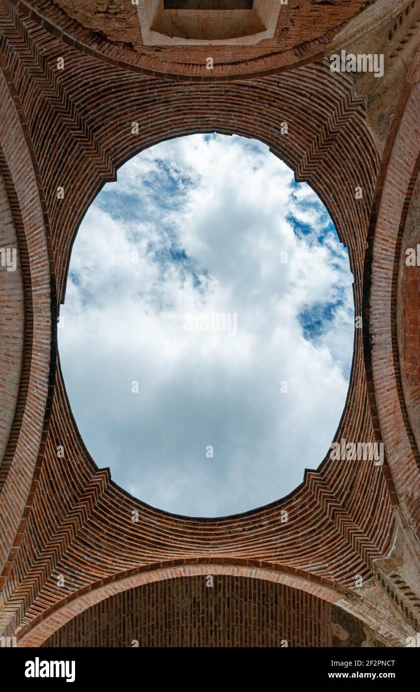 Artistic view over the missing dome of the ancient cathedral ruins of Antigua city due to an earthquake, Guatemala. Stock Photo