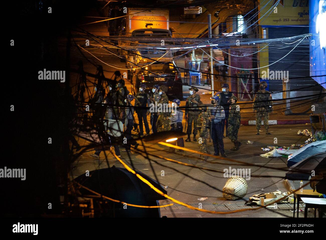 Myanmar military and police seen looking out for residents and protesters hidden in buildings after an anti military coup demonstration.Myanmar police attacked protesters with rubber bullets, live ammunition, tear gas and stun bombs in response to anti military coup protesters on Friday. Two reported dead. Myanmar's military detained State Counsellor of Myanmar Aung San Suu Kyi on February 01, 2021 and declared a state of emergency while seizing the power in the country for a year after losing the election against the National League for Democracy (NLD). (Photo by Theint Mon Soe/SOPA Images/ Stock Photo