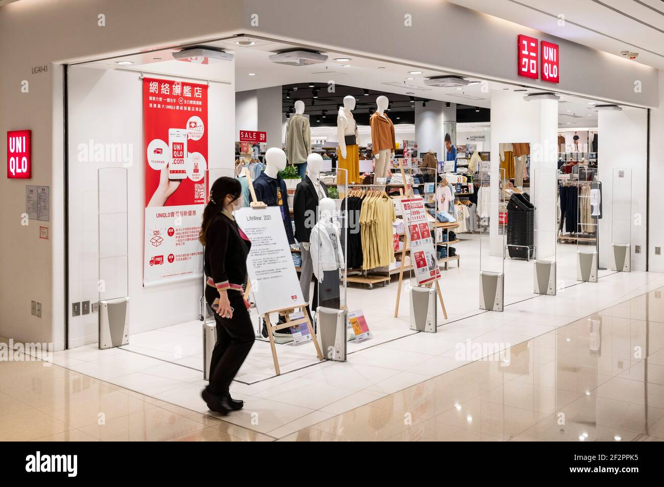 Hong Kong, China. 12th Mar, 2021. A woman walks past the Japanese