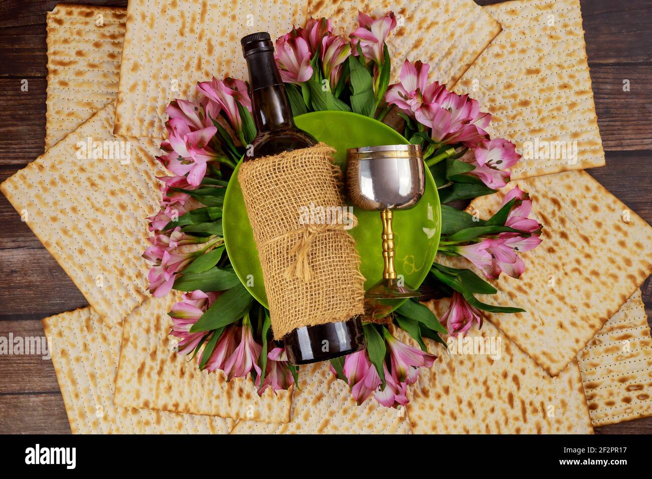 Matzos unleavened bread with wine bottle and kiddush cup. Jewish Pesach