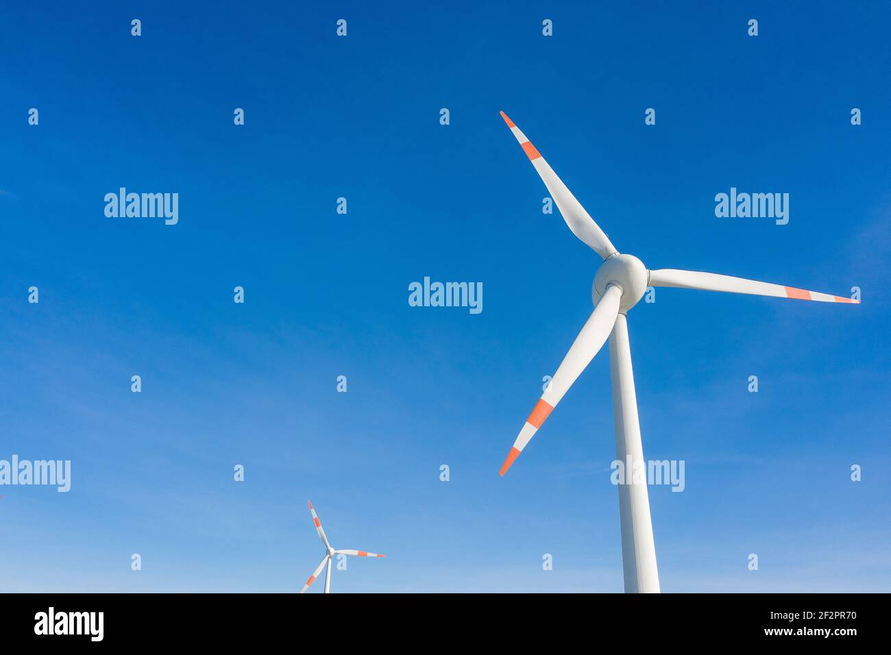 Wind turbines against a blue sky Stock Photo
