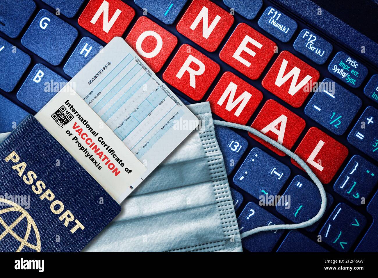 Passport, boarding pass and certificate of COVID-19 vaccination on keyboard with face mask. Vaccine passport concept of new normal future travel with Stock Photo