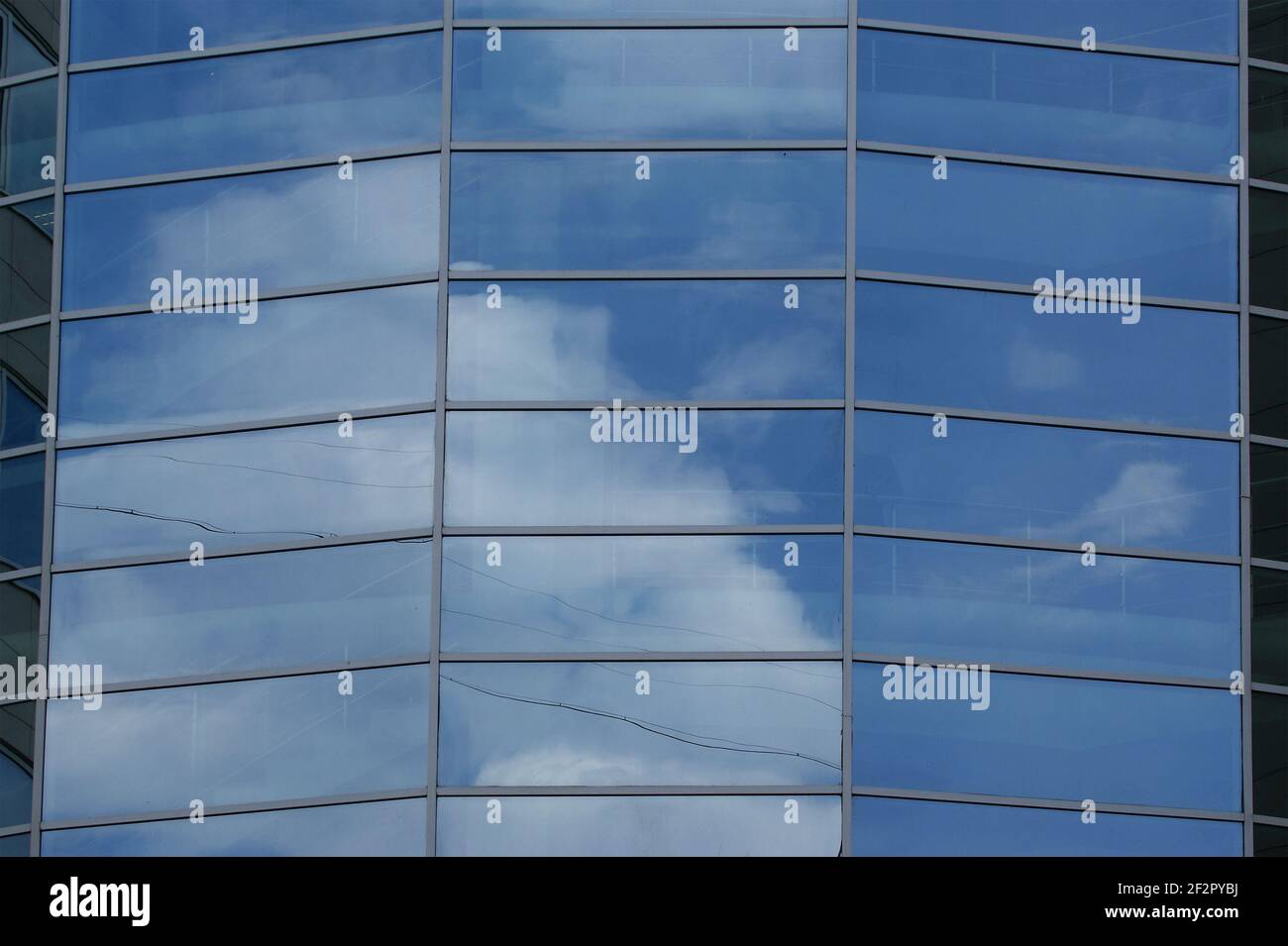 Reflection of a cloudy sky in glass wall of an office building Stock ...