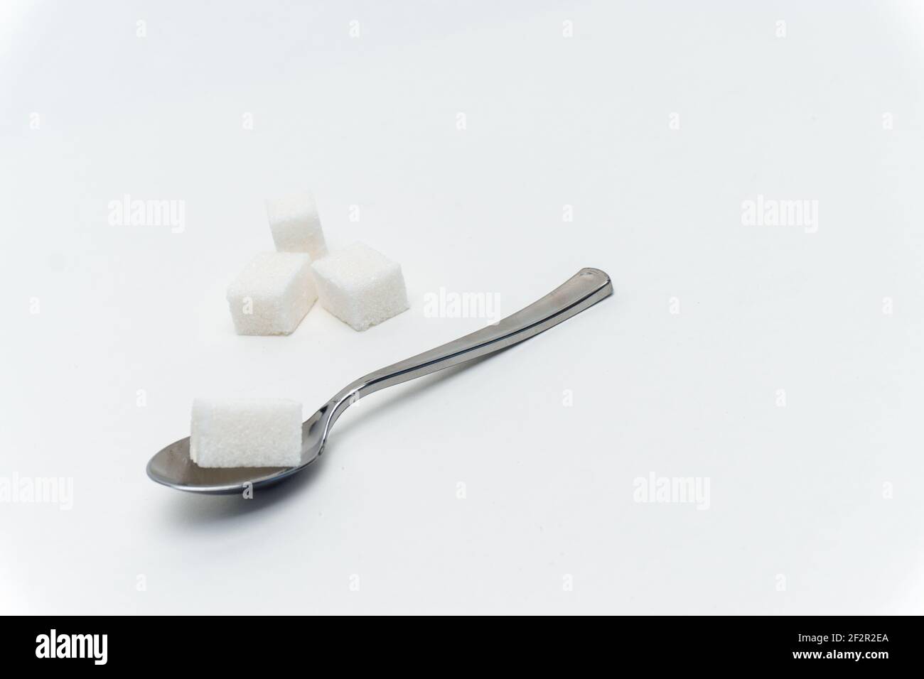 sugar cubes per teaspoon calories sweets light background Stock Photo