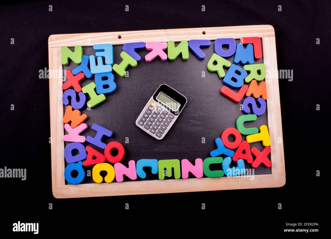 Calculator and Colorful Letters of Alphabet made of wood Stock Photo