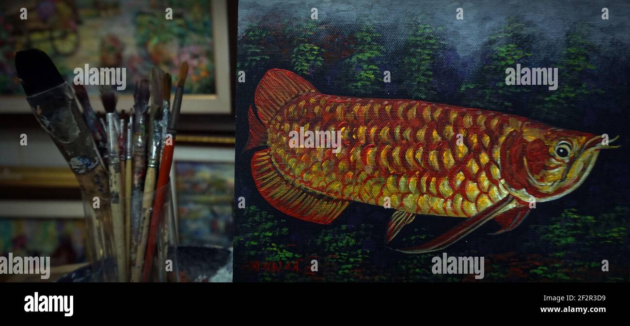 Paint brushes and paints for drawing , Asian arowana Stock Photo