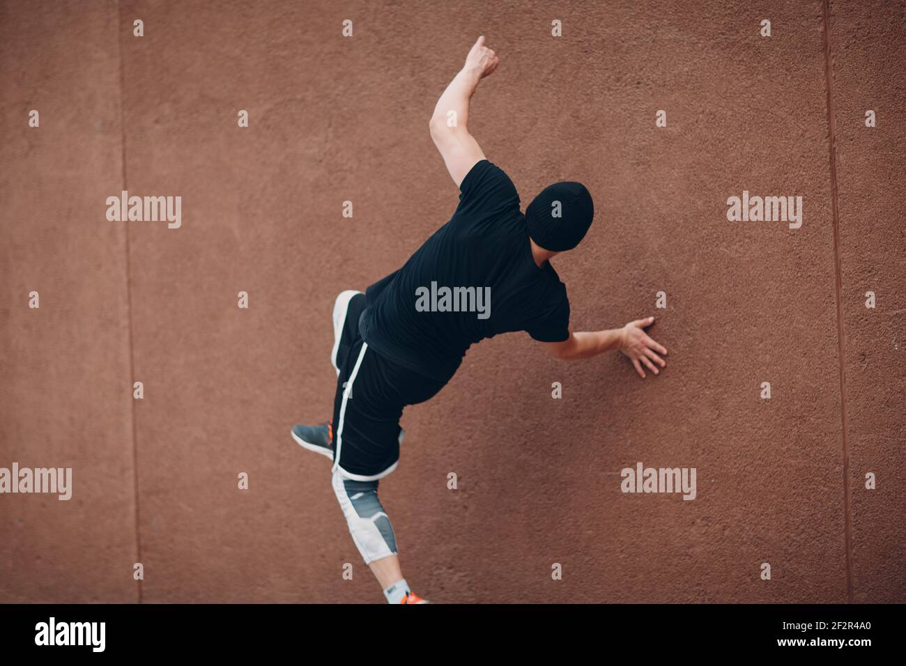 Young sporty guy doing parkour at the city street Stock Photo