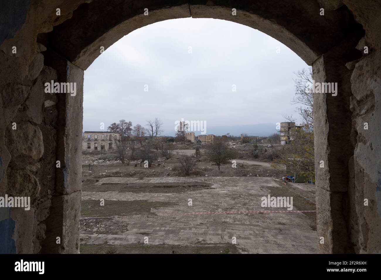 AGDAM, AZERBAIJAN - DECEMBER 14: View through the19th century Juma Mosque the only building left standing in the town of Agdam which was destroyed by Armenian forces during the First Nagorno-Karabakh War on December 14, 2020 in Agdam, Azerbaijan. The town and its surrounding district were returned to Azerbaijani control as part of an agreement that ended the 2020 Nagorno-Karabakh War. Stock Photo