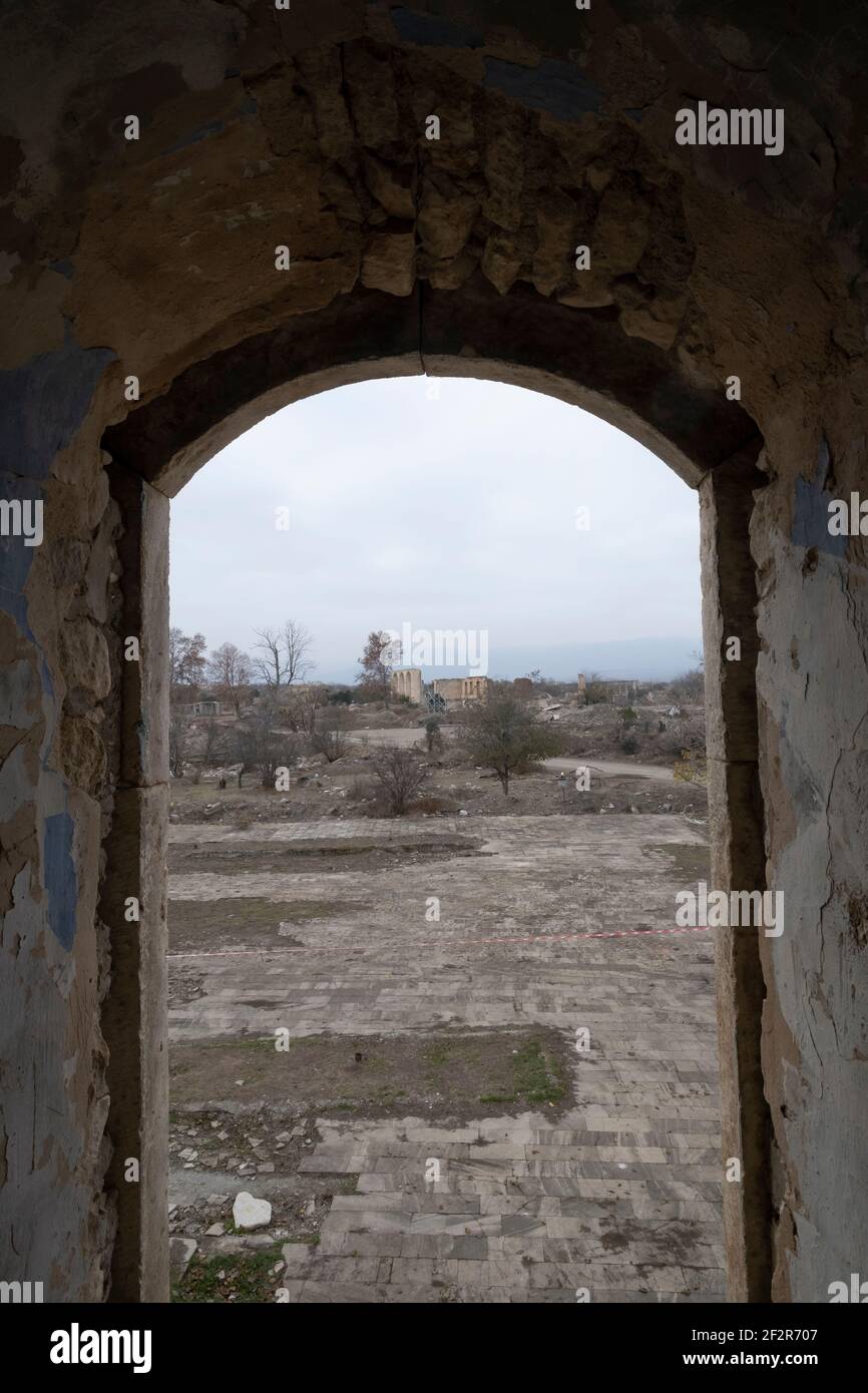 AGDAM, AZERBAIJAN - DECEMBER 14: View through the19th century Juma Mosque the only building left standing in the town of Agdam which was destroyed by Armenian forces during the First Nagorno-Karabakh War on December 14, 2020 in Agdam, Azerbaijan. The town and its surrounding district were returned to Azerbaijani control as part of an agreement that ended the 2020 Nagorno-Karabakh War. Stock Photo