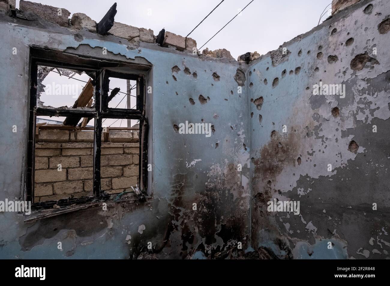 AGDAM DISTRICT, AZERBAIJAN - DECEMBER 14: Interior of a house partially destroyed after it was hit on 13 October by a rocket fired by Armenian forces in the village of Quzanli on December 14 2020 in Jabrayil Rayon of Azerbaijan. Heavy clashes erupted over Nagorno-Karabakh in late September during which more than 5,600 people, including civilians, were killed. The sides agreed to a Russia-brokered cease-fire deal that took effect on November 10, resulting in Azerbaijan regaining control over swaths of territory ethnic Armenians had administered for almost 30 years. Stock Photo