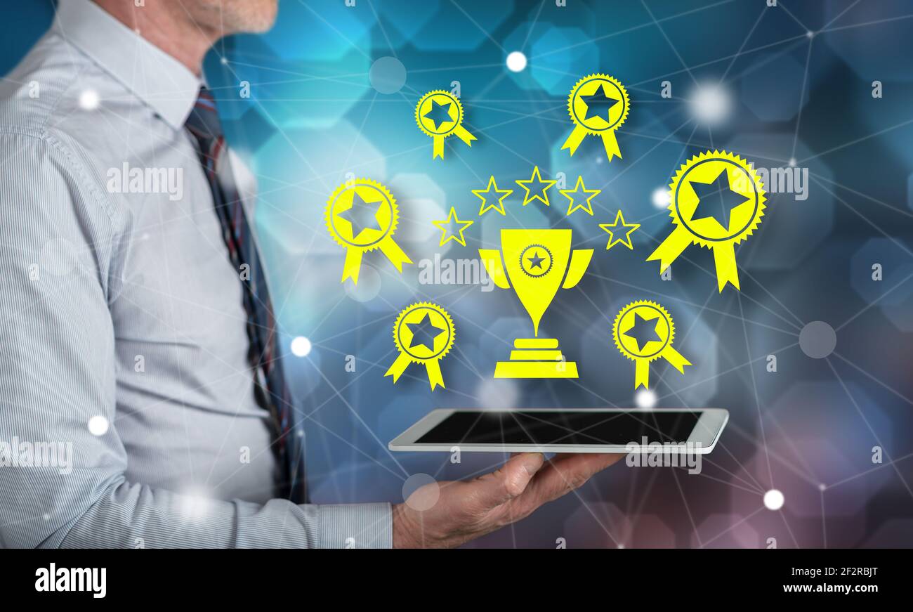 Quality concept above a tablet held by a man Stock Photo