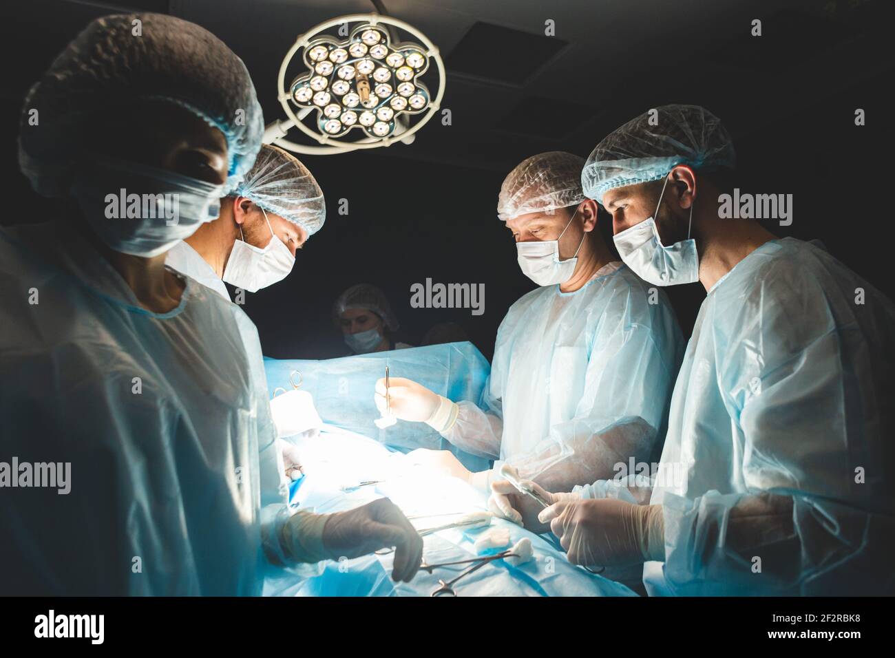 An international professional team of surgeon, assistants and ...