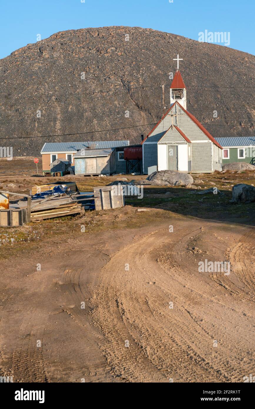 Small anglican church in the Canadian arctic in the golden hour. St. Michael and All Angels Church in remote Inuit community of Qikiqtarjuaq Stock Photo